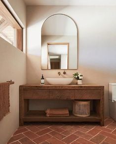 a bathroom with a sink, mirror and toilet