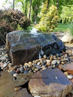 a large rock with water coming out of it