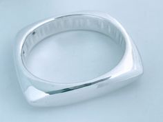 "Vintage Bat Ami Electroformed Puffed 925 Sterling Silver Squared Bangle Bracelet. Chunky geometric lines contrasted with high polish high shine silver provide a clean but bold modern look.  Stamped Maker Mark: BatAmi 925 Weight: 36 grams Size: Inside circumference 7 1/2\", Inside Diameter across 2 1/2\", Width 1/2\" at widest point.  Condition: Vintage pre-owned ready to wear. High polish finish is in very good conditon with minimal surface wear, there are a couple of small dings from wear.  Se Contemporary Sterling Silver Bangle Bracelet, Contemporary Sterling Silver Bangle Bracelet For Formal Events, Contemporary Sterling Silver Bangle For Formal Occasions, Contemporary Sterling Silver Bangle Bracelet Gift, Contemporary Sterling Silver Bracelet Gift, Contemporary Sterling Silver Bracelet As Gift, Modern Sterling Silver Rectangular Bracelet For Formal Events, Modern Bangle, Geometric Bangle