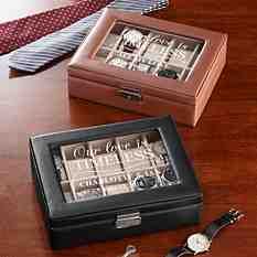 two personalized watches in a leather box on a wooden table next to a tie