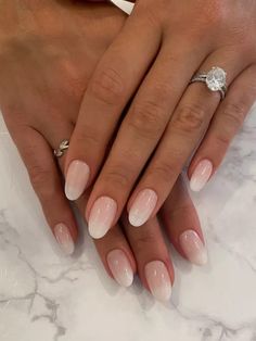 a woman's hands with french manies and a diamond ring on her finger