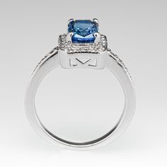 This gorgeous no heat blue sapphire ring is centered with a 1.64 carat cushion cut sapphire set into a four-prong head and is bordered with eighteen (18), bead set, round brilliant cut diamonds. The top face of the shank is accented with a row of seven (7), bead set, round brilliant cut diamonds on each side. The ring measures 10.2mm at the top, rises 6.4mm above the finger, tapering to 1.7mm wide and 1.1mm thick at the base of the shank. The ring is currently a size 4.75 and we offer complimentary resizing to fit. Blue Sapphire Engagement Ring, Blue Sapphire Ring, Sapphire Engagement Ring Blue, Sapphire Engagement Ring, Bead Set, No Heat, Blue Sapphire Rings, Sapphire Engagement, Diamond Halo