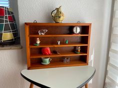 a wooden shelf sitting on top of a white table