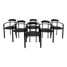 set of six chairs with black leather seats and backrests in the style of philippe van