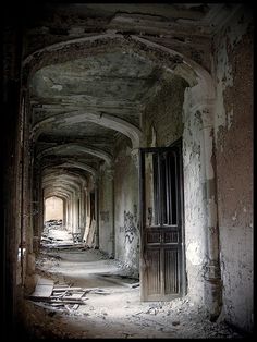 an old building with lots of windows and peeling paint on the walls is shown in this image