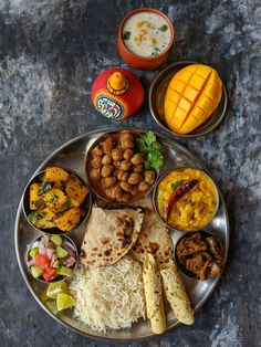 an assortment of food on a metal plate