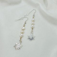 Our Snowflake Earrings of Sterling Silver Snowflakes, Sterling Silver Beads and Freshwater Pearls are elegant and classic. They look fabulous paired with our Callie Necklace and Callie Bracelet. This is a limited edition. Elegant Snowflake Jewelry For Festive Occasion, Elegant Sterling Silver Snowflake Jewelry, Elegant Christmas Jewelry With Dangle Shape, Elegant White Snowflake Earrings, Elegant White Christmas Earrings, Sparkling Pearl Earrings For Gift, Elegant Sterling Silver Pearl Earrings For Festive Occasions, Elegant Snowflake Earrings For Parties, Festive Sterling Silver Pearl Drop Earrings