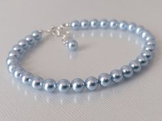 This is a RESERVED listing for Special Customer! Wedding Light Blue Blush Blue Colored Pearl Silver Dainty Bridal Bracelet. BRACELET is about 8 inches (20.3cm) long plus 1 inch extender chain. BRACELETS SECTION: https://www.etsy.com/shop/LanaChayka?ref=simple-shop-header-name&listing_id=892586384&sort_order=date_desc§ion_id=14226470 BRIDAL BRACELETS SECTION: https://www.etsy.com/shop/LanaChayka?ref=seller-platform-mcnav§ion_id=25839214 Classic and elegant, this dainty bracelet is perfect for wed Blue Round Beads Bracelet For Wedding, Blue Round Bead Bracelets For Weddings, Adjustable Blue Crystal Bracelet For Wedding, Light Blue Round Beads Jewelry For Wedding, Blue Round Beaded Bracelets For Wedding, Elegant Adjustable Light Blue Crystal Bracelet, Elegant Light Blue Adjustable Crystal Bracelet, Adjustable Blue Pearl Bracelet For Wedding, Elegant Adjustable Blue Pearl Bracelet