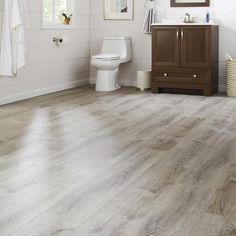 an image of a bathroom setting with wood flooring and white walls in the background