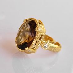 Smokey Quartz & Diamond Ring in 18k Solid Gold, This beauty is part of our exclusive a one of a Kind creation collection * 18k solid Gold * Pristine natural 1x1.8cm faceted Oval Smokey Quartz Gemstone * 2 Vs si Brilliant quality 0.3ct Diamonds * All our Stones are Ethically sourced. * Size adjustment from 5us to 8 us Included * Price includes shipping * Custom duty charges are regulated by your country upon delivery. There is no custom duty charges for all orders delivered to the EU countries. * For time sensitive orders please let us know and we will do our best to accommodate you Custom orders Welcomed! Elegant Yellow Gold Topaz Ring With Diamond Accents, Luxury 14k Gold Topaz Ring, Luxury Faceted Rings For Formal Occasions, Elegant Yellow Gold Topaz And Diamond Ring, Elegant Faceted Yellow Gold Topaz Ring, Elegant Faceted Gold Topaz Ring, Elegant Gold Faceted Topaz Ring, Elegant Oval Yellow Gold Topaz Ring, Formal Yellow Gold Faceted Rings