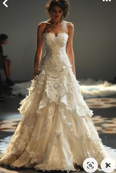 a woman is walking down the runway in a wedding dress