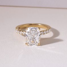 a cushion cut diamond ring set in yellow gold