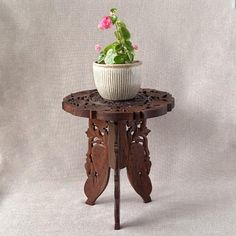 a potted plant sitting on top of a wooden table