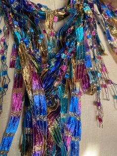 Multicolor scarf for women. Unique scarf handmade for women. Boho scarf for festivals and formal gatherings. Stunning color combination with gold makes this a showstopper. Fuchsia, royal blue, teal green, brass gold with lot of gold metallic sparkle, if you love lot of bling and color this is the accessory for you.  Wear it with matching color jewelry to complete your look. Very rich looking scarf. Masquerade ball comes mind with this color combination. Hand wash in lukewarm water with mild soap, don't rub or wring, squeeze of excess water and hang to dry.  Comes with nice organza satchel for traveling or gift giving. Store the ribbon scarves flat in a drawer or hang them up.  Handmade in United States of America.  Visit the store front at  www.Etsy.com/shop/thinkerbella for more color and Bohemian Multicolor Festive Scarves, Festive Multicolor Silk Scarf, Festive Multicolor Bohemian Scarves, Festive Bohemian Multicolor Scarves, Festive Bohemian Multicolor Scarf, Traditional Scarves For Festivals As Gifts, Unique Handmade Scarves For Gifts, Traditional Scarf For Festivals As A Gift, Unique Handmade Scarves As Gifts