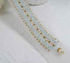 Woven Bracelet with Robins Egg Blue Seed Beads Gold Crystals and Pearl Accents Elegant Handmade Light Blue Beaded Bracelets, Gold Crystals, Woven Bracelet, Robins Egg, Woven Bracelets, Robins Egg Blue, Robins, Braided Bracelets, Crystal Pearls