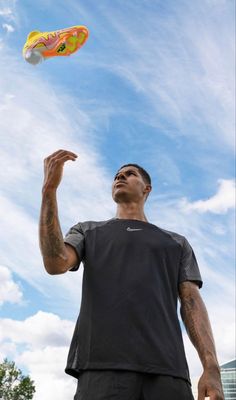 a man is playing with a frisbee in the air on a sunny day