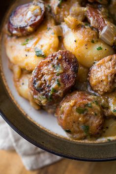 a close up of a plate of food with meatballs and potatoes on it,