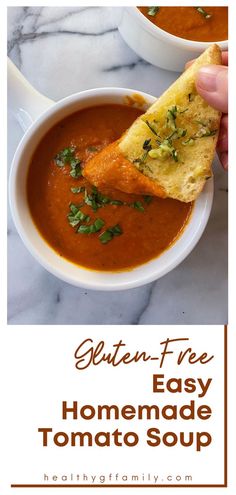 a hand holding a piece of bread over a bowl of tomato soup with the words gluten - free easy homemade tomato soup