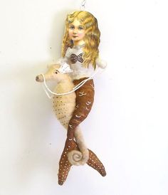 a ceramic ornament with a girl riding a deer on it's back