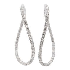 Gender: Ladies    Metal Type: 18K White Gold    Length: 1.75 Inches    Width: 1.25 Inches    Weight: 10.07 grams  Ladies 18K white gold diamond hoop earrings. Engraved with "18K" and "750".  Pre-owned in excellent condition. Might shows minor signs of wear.  Pavé set in 18 Karat White Gold with:  Ninety-two (92) round brilliant cut natural diamonds:  Measurements: 2.10mm - 2.20mm in diameter x ~1.31mm in depth.  Weight Range: 0.035 ct. - 0.040 ct.  Estimated Total Weight: 3.500 ct.  Color: G - H  Clarity: VS1 - VS2  Cut: Very Good  Polish: Very Good  Symmetry: Very Good  TOTAL WEIGHTS:  Total weight of diamond(s):~3.50 ctw.  Please reference the dimensions noted in the description above for the most accurate measuremens. Formal Diamond Hoop Earrings With Pave Setting, Formal Diamond White Hoop Earrings With Pave Setting, Platinum Hoop Earrings With Single Cut Diamonds, White Diamond Hoop Earrings For Formal Occasions, Wedding Platinum Hoop Diamond Earrings, Formal White Diamond Hoop Earrings, Diamond White Platinum Hoop Earrings With Pave Setting, Diamond White Platinum Hoop Earrings With Diamond Accents, Platinum Hoop Earrings With Pave Setting In Diamond White