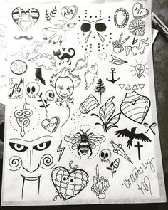 a sheet of paper that has various tattoos on it, including eyes and other things