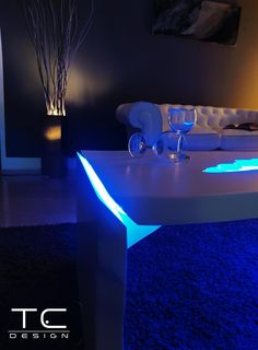 a living room filled with furniture and blue lighting