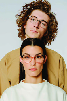 two people with glasses are posing for the camera