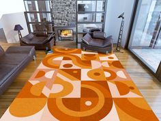 a living room with two couches and a rug on the floor in front of a fireplace