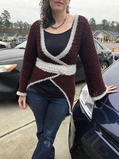 a woman standing next to a parked car