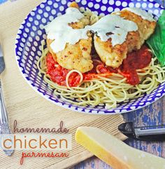 chicken parmesan with tomato sauce in a blue and white bowl on a wooden table