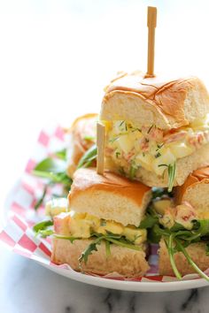 several sandwiches stacked on top of each other with toothpicks sticking out of them