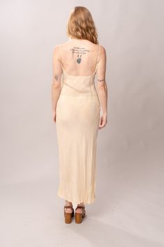 Simple and elegant 1930’s/40’s sheer cream rayon bias cut maxi slip dress with spaghetti straps. Excellent vintage condition, with normal wear and condition for its age. Best fits modern size S, but bias cut gives it some stretch in waist and hips. Length 59”Pit to pit 17”Waist 26-36”Hips 32-42” Model’s Measurements:Height 5’9”Chest 34”Waist 29”Hips 36.5” Sleeveless Bias-cut Beige Slip Dress, Sleeveless Bias Cut Beige Slip Dress, Sleeveless Beige Slip Dress Bias Cut, Vintage Cream Slip Dress, Sheer Vintage Slip Dress, Vintage Silk Slip Dress With Spaghetti Straps, Fitted Cream Slip Dress With Bias Cut, Vintage Sheer Slip Dress, Vintage Silk Slip Dress With Bias Cut