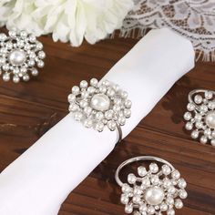 the napkin ring is adorned with pearls