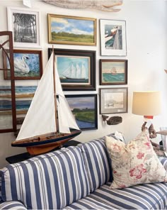 a living room filled with furniture and pictures on the wall