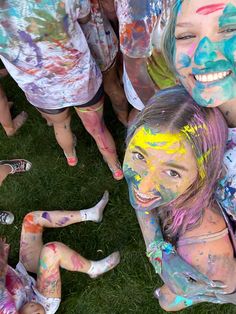 several girls covered in colorful paint posing for the camera