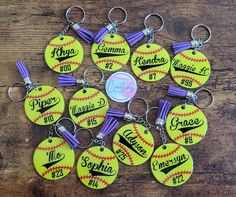 a bunch of softball key chains with names on them