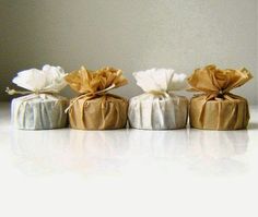 three wrapped cakes sitting on top of a table