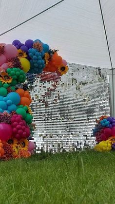 there are many balloons in the grass