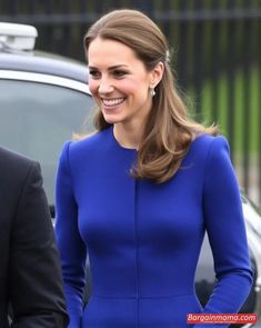 the duke and kate are all smiles as they walk down the street in their blue outfits