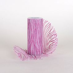 a roll of pink and white tissue paper on a white surface with lines drawn across it