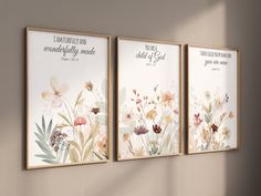 three framed art prints with flowers and bible verses on the wall next to a window