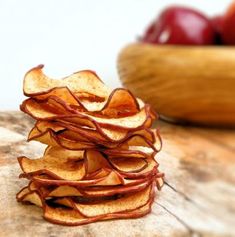 a pile of potato chips sitting on top of a wooden table