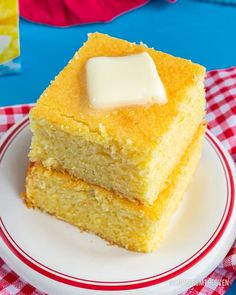 two pieces of cornbread on a plate with a red and white checkered tablecloth