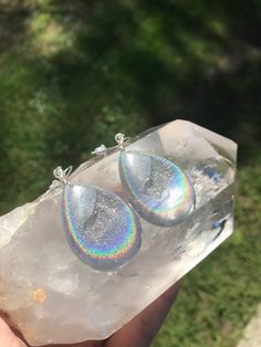 These holographic Teardrop geode earrings made from resin shift from clear to a beautiful sparkly rainbow. They are lightweight and won't bother your ears. Made by Katie Glover Resin Art by Katie 2020 Contact me on my Instagram @123pour if you would like additional photos or videos of this product.Please be aware that this is handmade art and perfection has no place in art. However, this was crafted with love and intention and I hope you are satisfied with your purchase. Your purchase is not ref Silver Resin Drop Earrings, Iridescent Teardrop Hypoallergenic Jewelry, Unique Iridescent Teardrop Earrings, Iridescent Resin Drop Earrings, Iridescent Teardrop Earrings For Gift, Iridescent Drop Earrings For Gift, Iridescent Glitter Earrings As Gift, Iridescent Glitter Earrings For Gift, Iridescent Dangle Resin Earrings