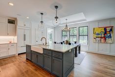 a large kitchen with an island in the middle