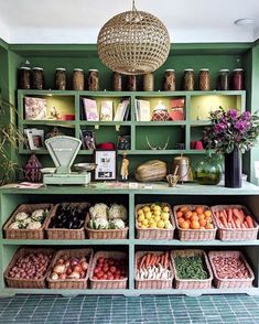 a green shelf filled with lots of fresh produce