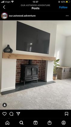 a tv mounted on the wall above a fire place in a room with carpeted flooring