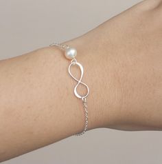 You will receive 2 infinity sterling silver bracelets, each packaged with a very presentable gift box (as pictured) This original design and simply bracelet consists of a sterling silver initial infinity and one customize birthstone. sterling silver chain . ALL STERLING SILVER COMPONENTS Please leave stone choices in your checkout note Elegant White Nickel-free Pearl Bracelet, Hypoallergenic Sterling Silver Pearl Bracelet, Minimalist Sterling Silver Pearl Bracelet For Wedding, Silver Bracelets Simple Design Gift, Elegant Infinity Jewelry For Wedding, Silver Bracelets For Gifts, Elegant Infinity Wedding Jewelry, Silver Bracelets With Simple Design For Gift, White Sterling Silver Bracelets For Bridesmaids