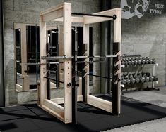 the gym equipment is made out of wood and has metal bars on each one side