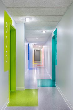 the hallway is painted bright green, white and blue with colorful numbers on each side